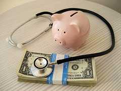 piggy bank, stethoscope, money