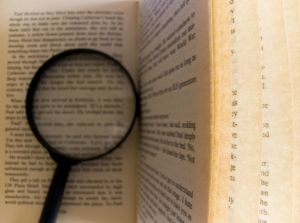 magnifying glass and book