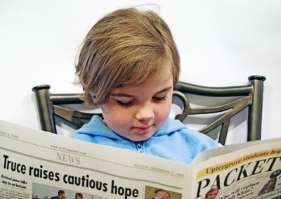 A child (not my gal) reading the paper